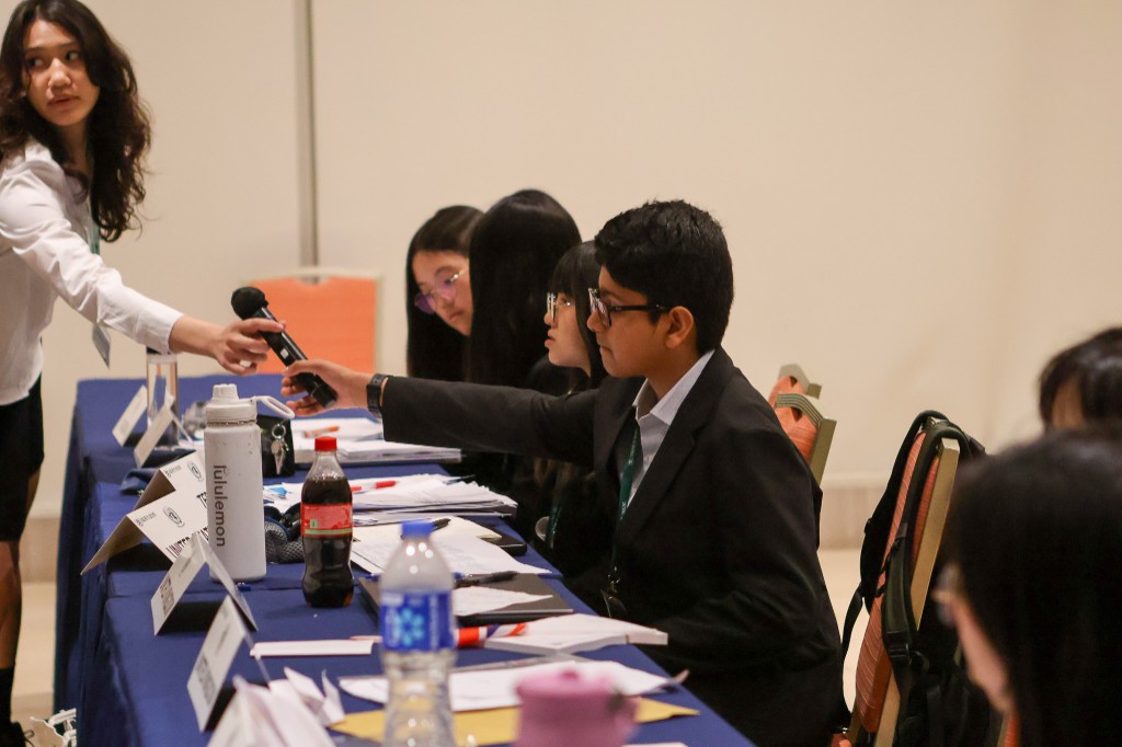Delegate receiving microphone at table