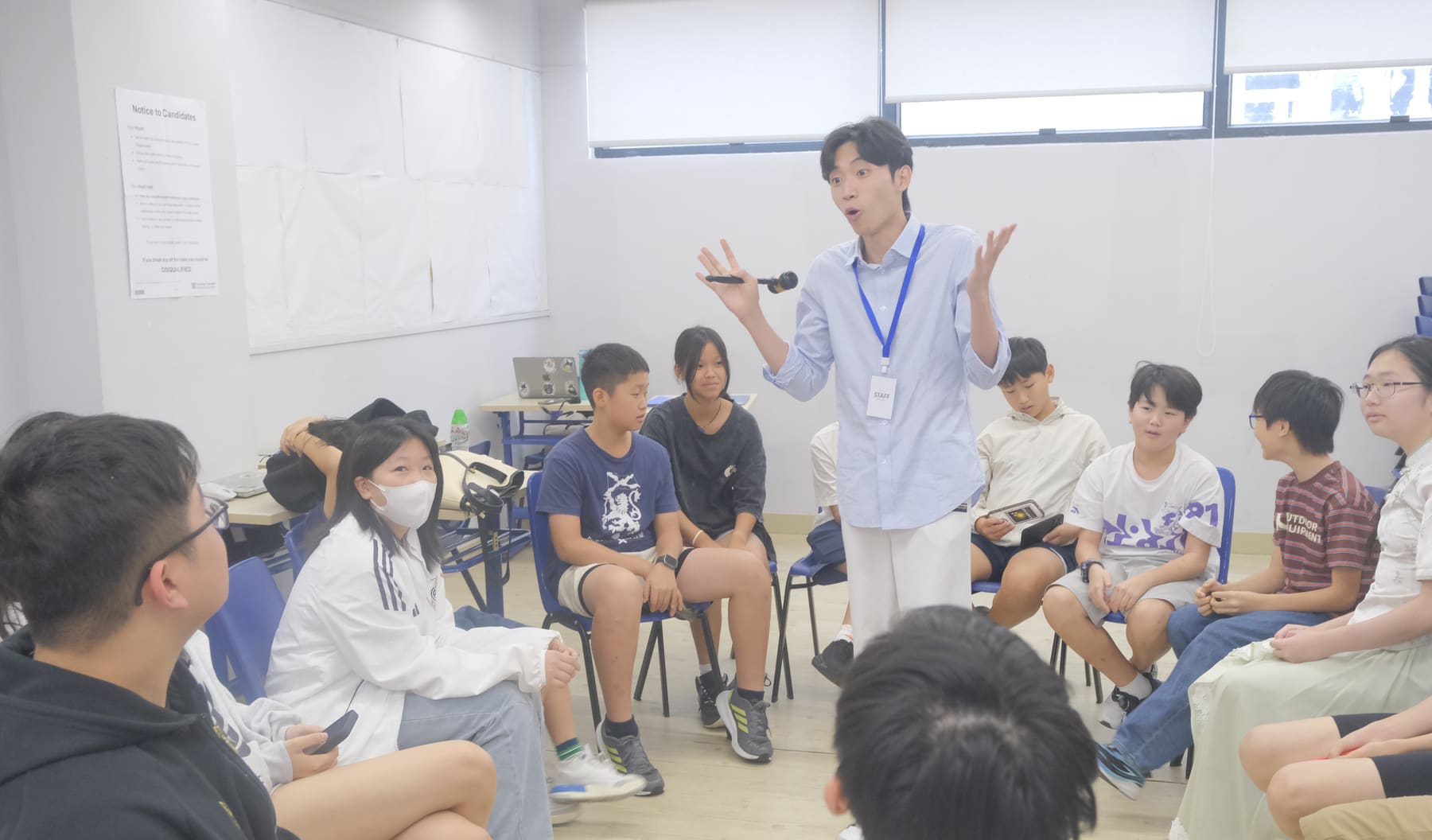 Instructor leading a debate circle with a microphone