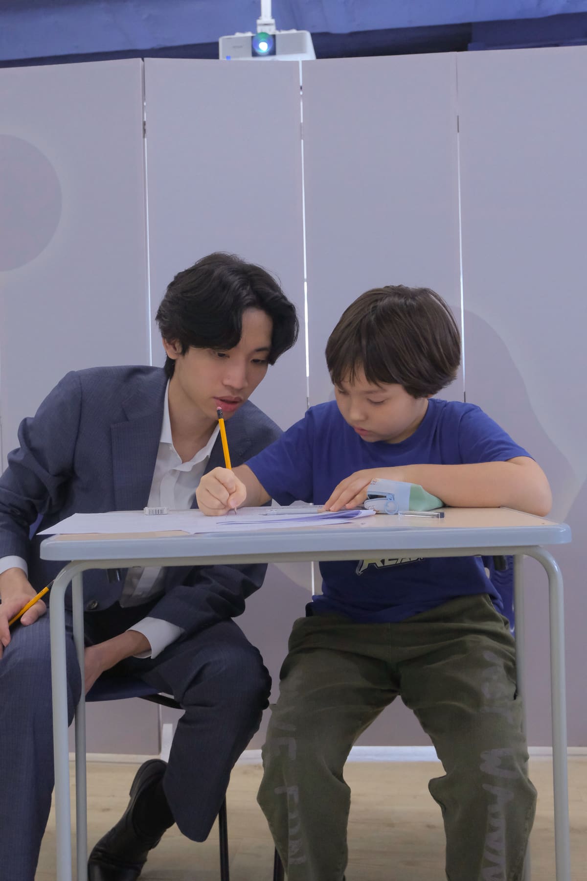 Coach working one-on-one with a student on a position paper