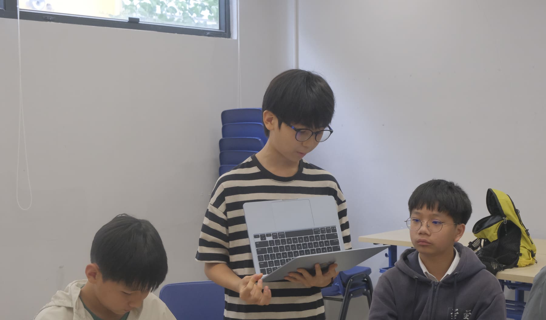 Student presenting research from a laptop